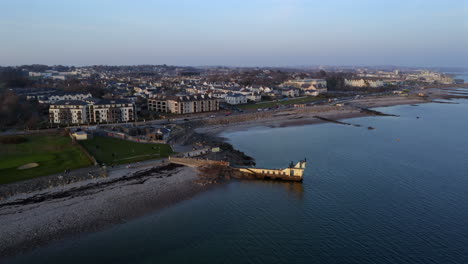 aerial of blackrock diving board along salthill promenade, the atlantic ocean stretching to the horizon with mutton island in backdrop