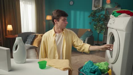 man doing laundry at home