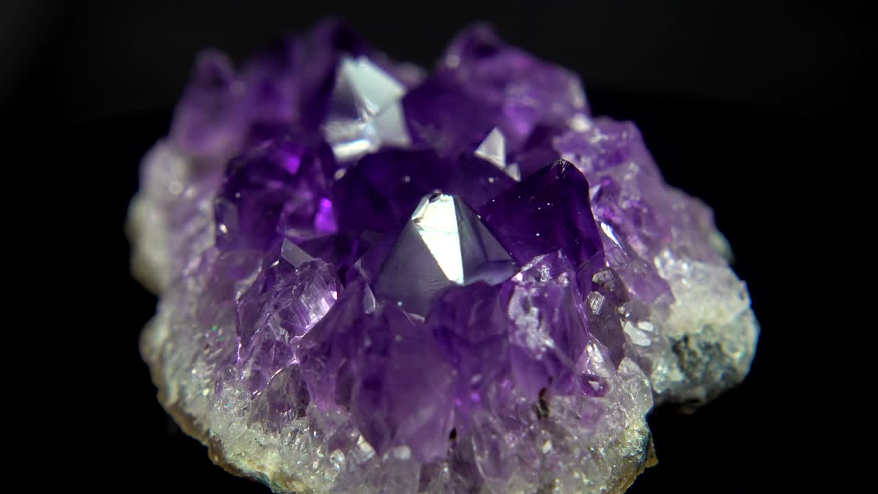 Seamlessly rotating a purple mineral (Amethyst) in front of black background