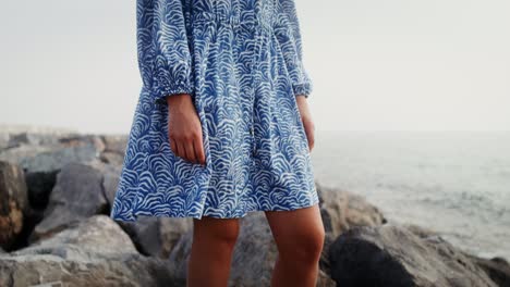 woman in a blue printed dress on the beach