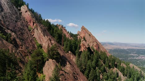 rising aerial drone footage of the flat irons rock formations in boulder, colorado