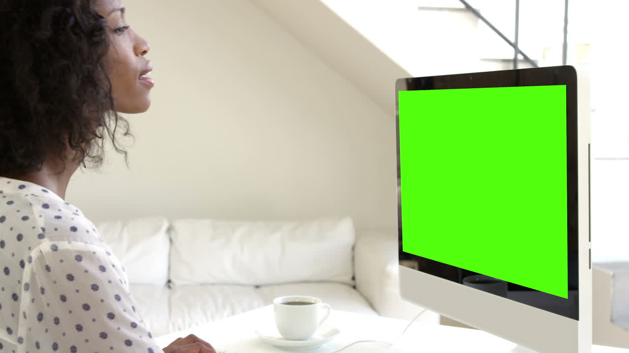 una mujer bonita usando una computadora y sonriendo.