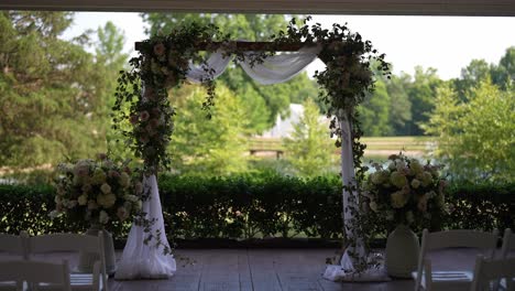 meticulously-designed-wedding-ceremony-setup-surrounded-by-the-serene-beauty-of-a-lake-and-towering-trees