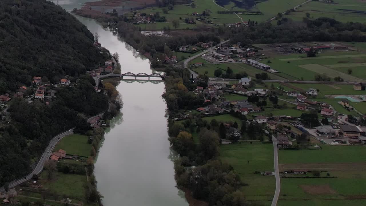 Stunning drone view of the river and villages in the Italian Alps
