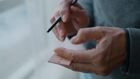 sizing a hole punch against a piece of leather