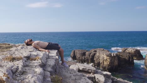 man stretching by the sea.