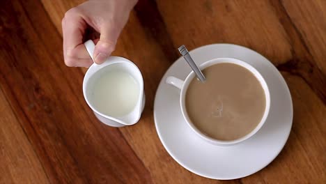 woman enjoying hot coffee with milk in a white cup stock video stock footage