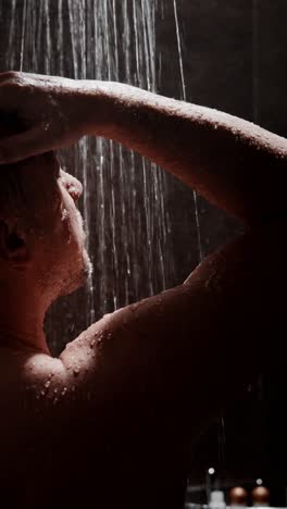 man washing hair in shower, enjoying moment of relaxation and self-care in private space