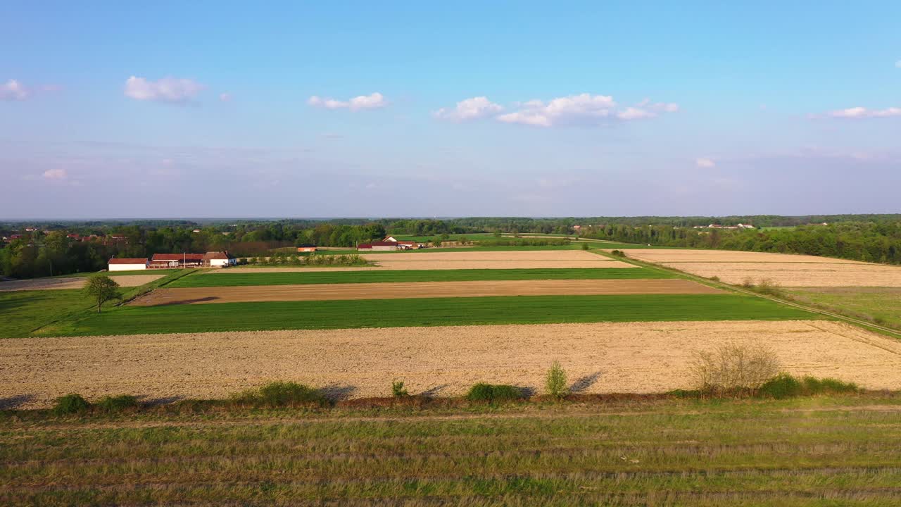 Beautiful areal footage of small village in Bosnia, flying above wheat fields, and agricultural places
