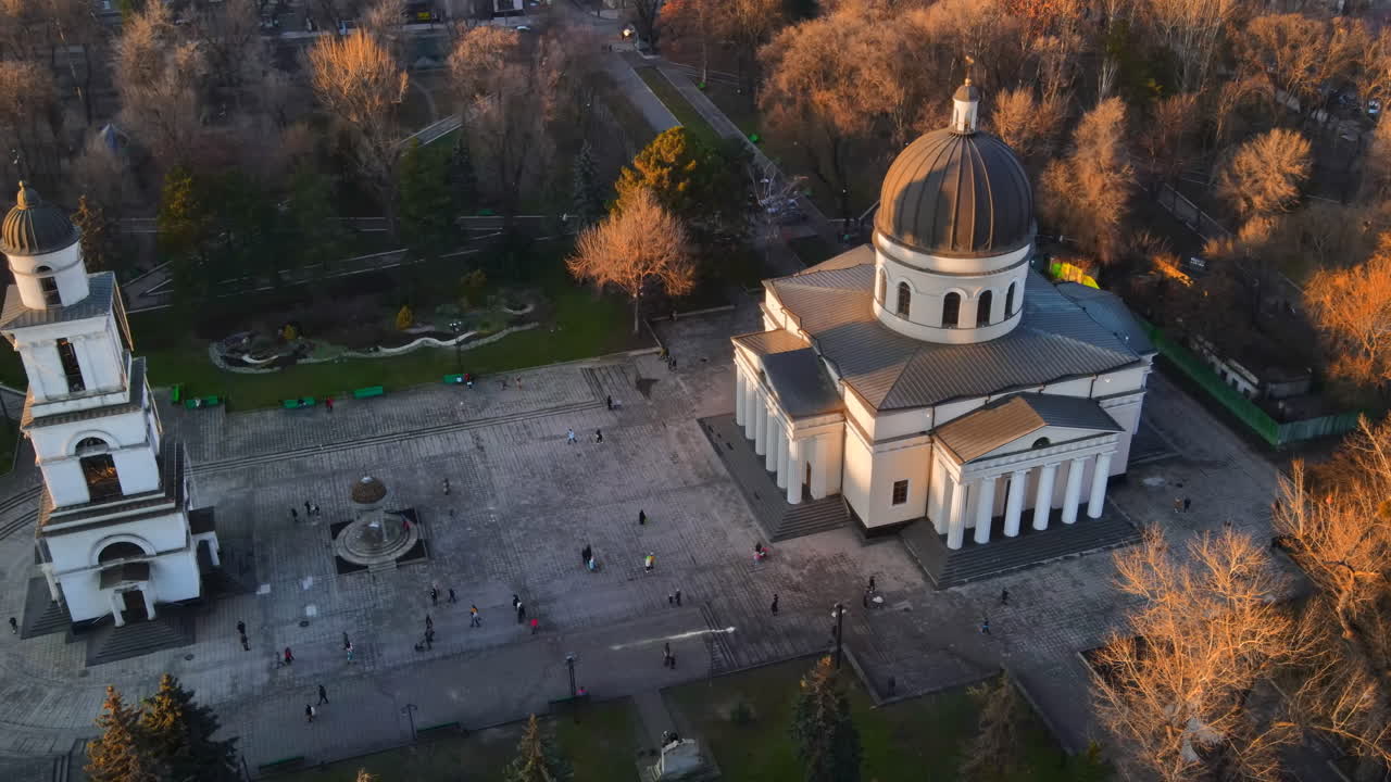 Aerial drone view of Chisinau. Panorama view of central park with bare trees and walking people, catheral. Moldova