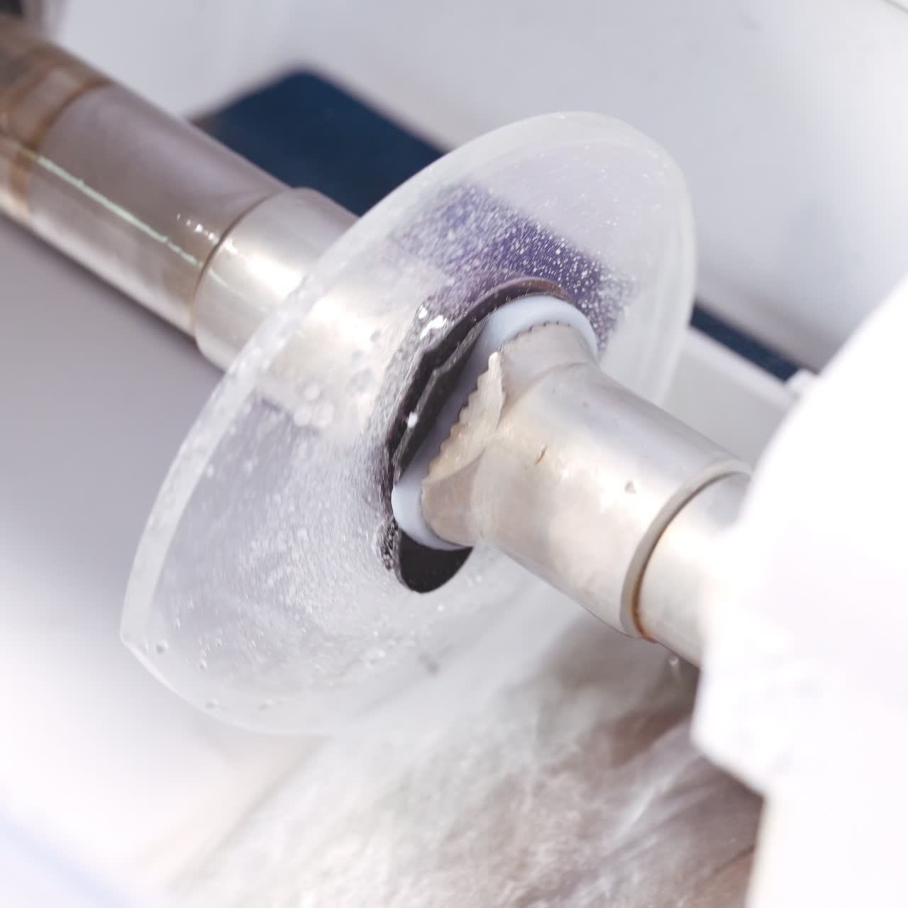 Eyeglass lens is inserted into a machine. Production of lens for spectacles with new technology. Close-up.