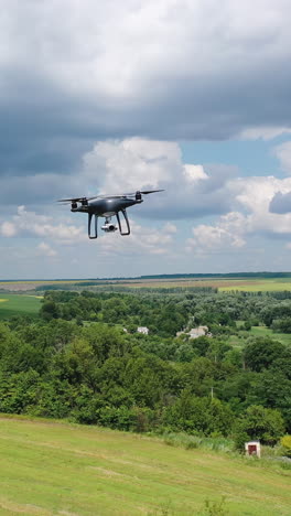 electric drone flies in the sky. drone quad copter with high resolution digital camera in the sky. vertical video