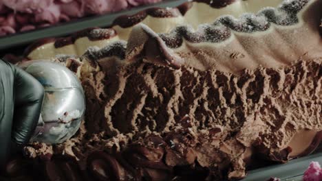 scooping chocolate ice cream with a scoop