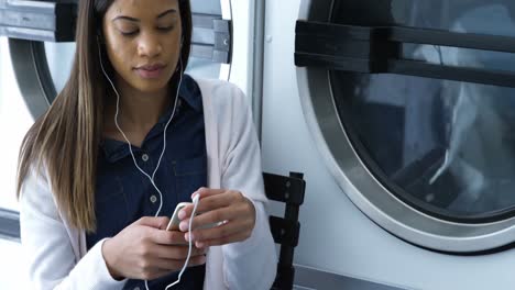 Woman-listening-music-on-mobile-phone-4k