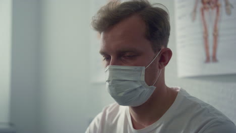 portrait patient waiting coronavirus test wearing protective mask in hospital.