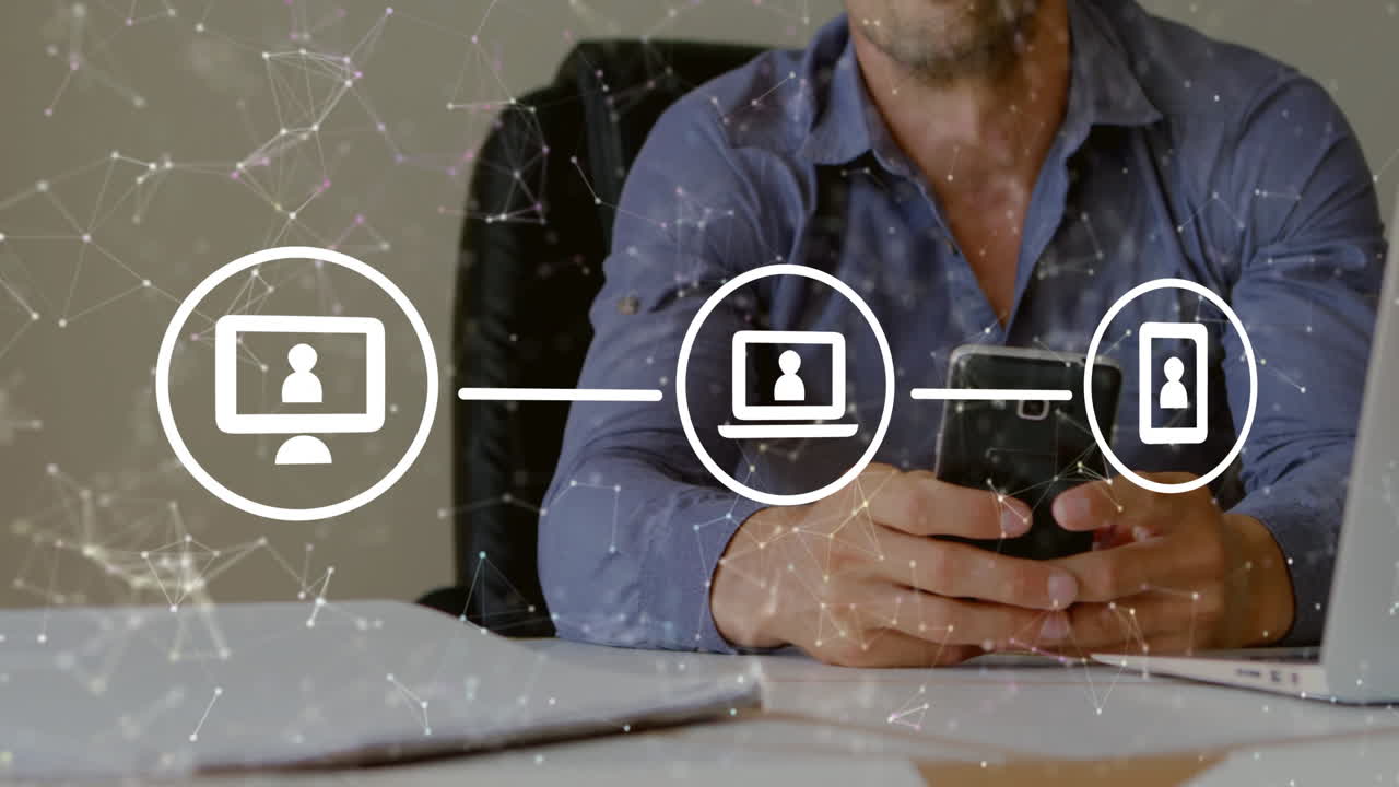 Man using smartphone at desk in business office, showing digital network graphics and device icons