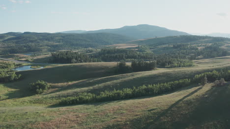 Aerial-panorama-of-scenic-British-Columbia-landscape-with-grassland,-mountains