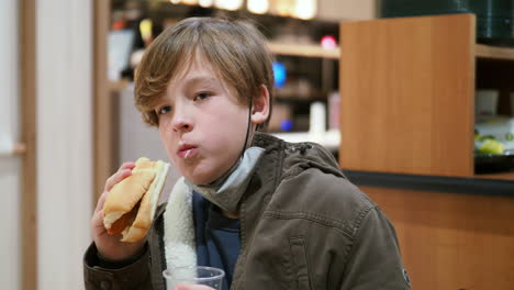 teen boy eating in a cafe