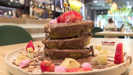 chocolate stuffed pancakes with berries and marshmallows