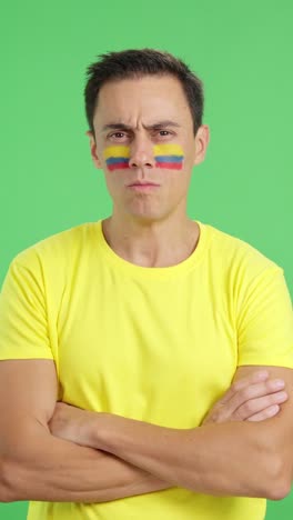 dignified and serious man with colombian flag painted on face