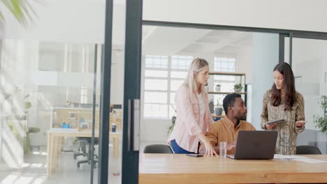 busy diverse business people discussing work with laptop in office in slow motion
