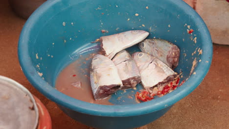 raw fish heads in a bowl.