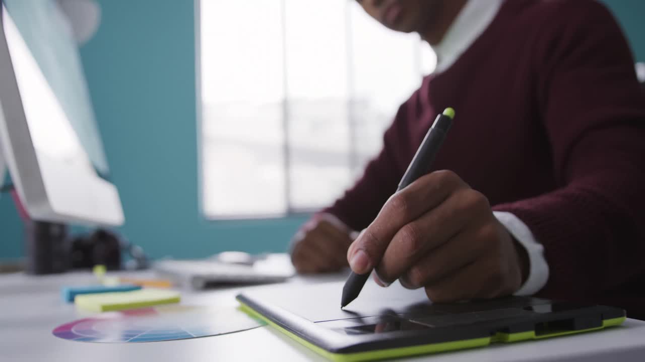 Mixed race man working on touch pad