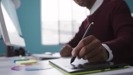 Mixed-race-man-working-on-touch-pad