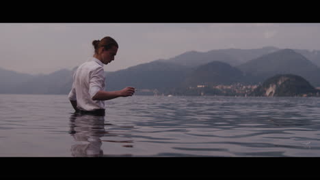 man smoking by the lake
