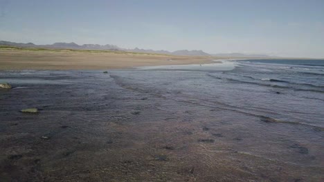 Low-Flight-over-Rare-Golden-Sandy-Beach-and-Ocean-During-Sunny-Summer-In-Snaefellsness-Peninsula,-Iceland