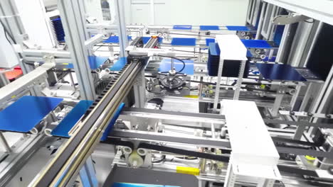 Photovoltaics-production-process-solar-panel-assembly-line-operated-by-high-tech-robot-arms-in-modern-sustainable-factory