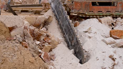 long stone chainsaw machine cutting blocks of limestone at a quarry, close up shot