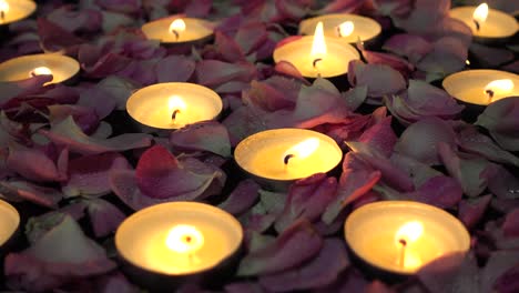 roses and candles on a black background.