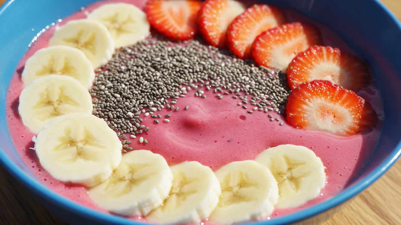 Vibrant Fruit Smoothie Bowl Topped with Fresh Banana, Strawberry, and Chia Seeds, Perfect for a Nutritious Breakfast or Refreshing Snack