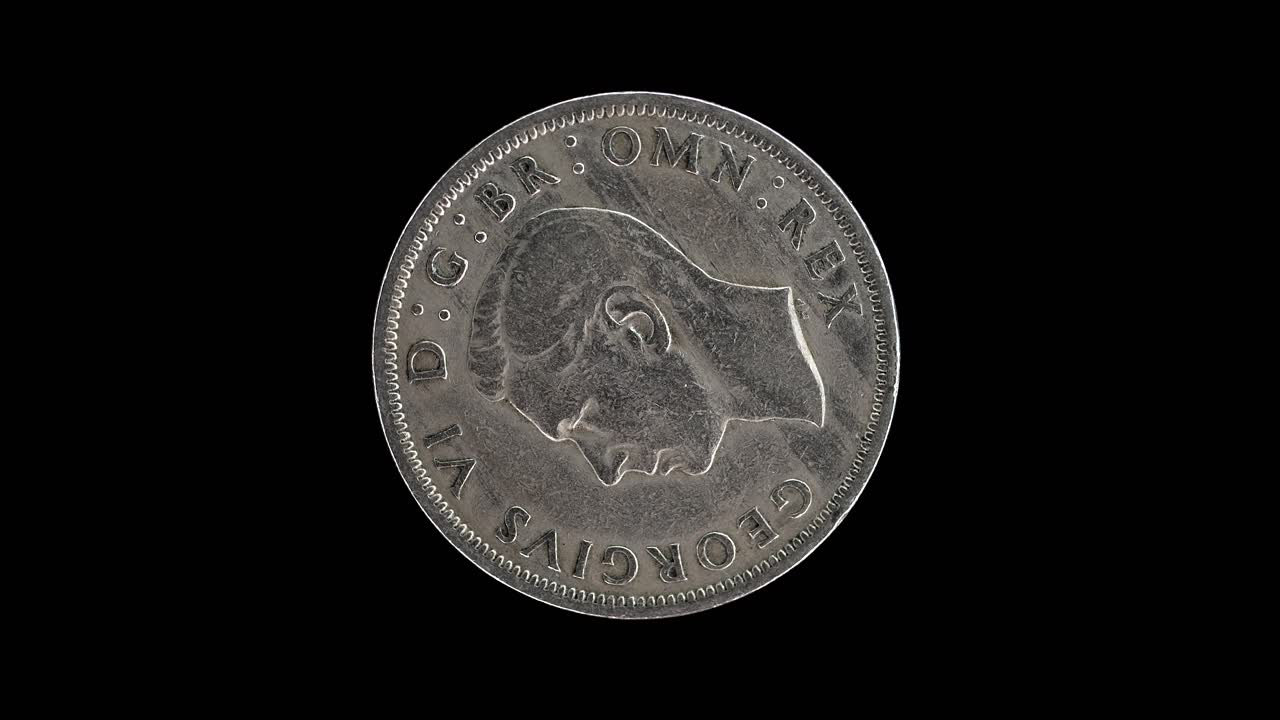 United Kingdom 1949 half crown coin obverse with portrait of King George VI rotating on black background