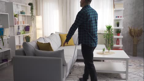 Blind-man-walking-around-the-house-with-his-cane,-sits-down-and-folds-his-cane.