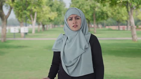 angry muslim woman talking to the camera in park