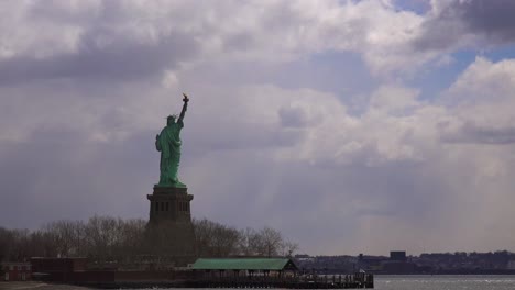 time lapse of clouds behind the statue of liberty in new york harbor