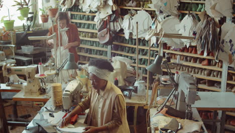 multiethnic women working in shoemaking workshop