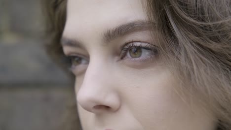 Close-up-portrait-of-beautiful-woman-looking-straight-in-central-London-street