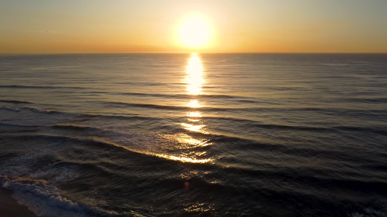 Aerial drone pan with magical morning landscape sunrise travel tourism orange sky ocean waves sea The Entrance Central Coast NSW Australia 4K
