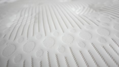 closeup of a white mattress with a textured surface