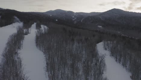 Flying-over-the-old-ski-trails-towards-the-top-of-an-abandoned-mountain-resort-AERIAL