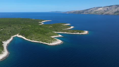 forested island of pakleni in daytime in the adriatic sea, croatia. - aerial shot