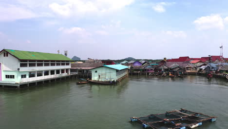 Houses-and-crude-fishing-nets-in-Koh-Panyee-floating-village,-Thailand