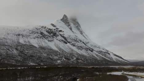 majestic snowy view of the otertinden mountain in signaldalen, norway - panning wide shot