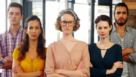 portrait of business team standing with arms crossed