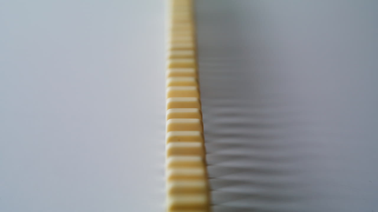 Domino set forming row under indoor light in silent composition. Blocks line