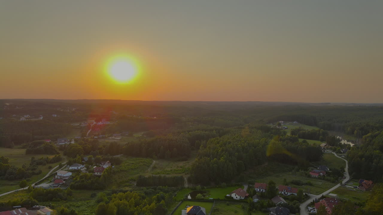 Aerial flight showing scenic housing area and beautiful sunset in background