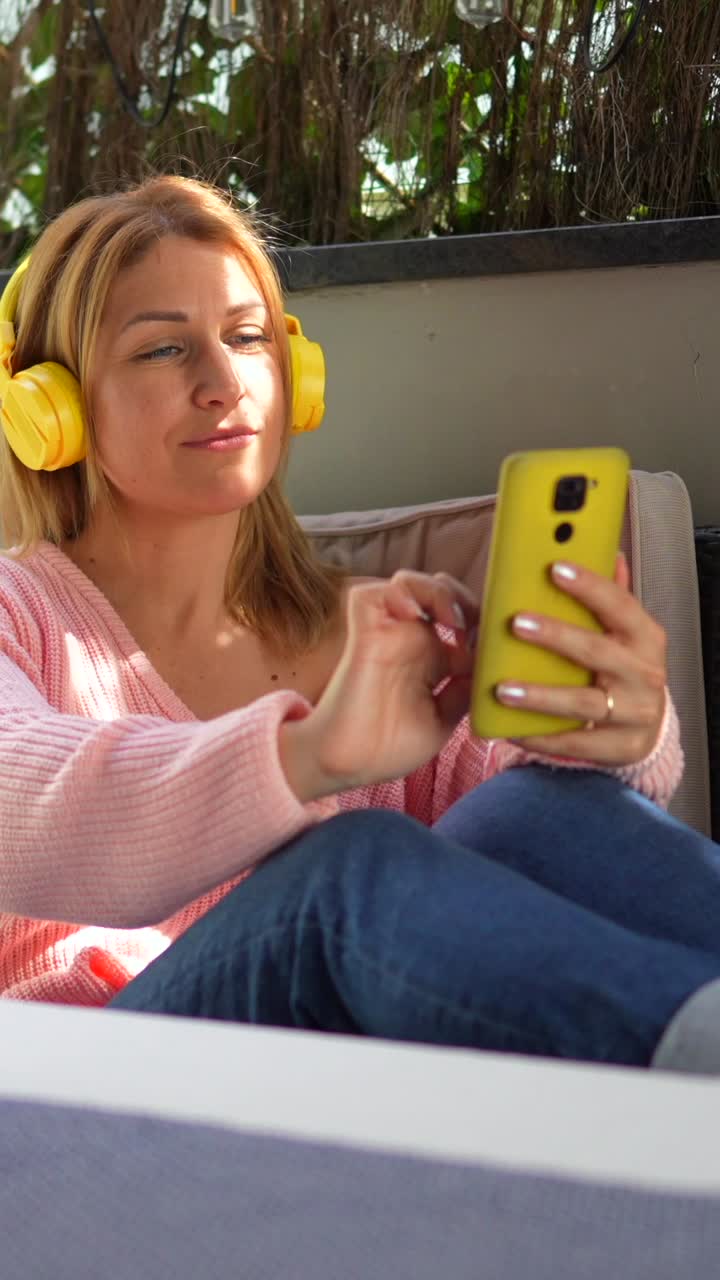 Woman Listening to Music with Yellow Headphones